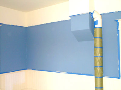 The new, blue dining room. Compare to yesterday's photo of the primed walls. Also, notice the absence of holes in the wainscot!