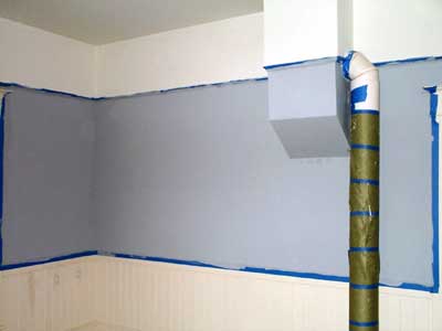 [photo of primed walls in the dining room]