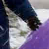 [photo of Kris sledding in the backyard]