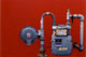 [photo of a gas meter on bright red wall]