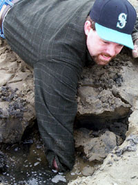 [photo of J.D. reaching into a trench to find a clam]