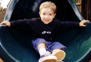 Kaden Bacon-Flick at the bottom of a slide Kaden Bacon-Flick at the bottom of a slide