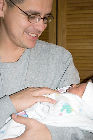 [photo of Sabino holding Isabel]